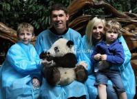 Tourists Hold Panda in Chengdu