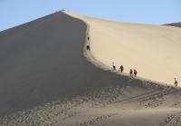 People Walking on the Echoing-Sand Mountain China