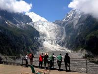 Tourists Watch the Glacier Fall in Hailuogou National Glacier Forest Park