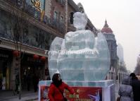 A Woman Poses in Front of an Ice Sculpture in the Central Street 