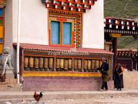 Two People Turn the Prayer Wheels in Riba Nunnery