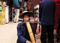 An Old Man is Smoking a Water Pipe in Xinjie Town